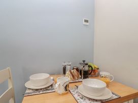 A dining table set with bowls and beverages at Bumble Bee Lodge in Filey