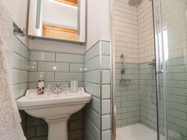 A bathroom with a shower and wash basin at Bumble Bee Lodge in Filey