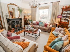 A living room with sofas and a fireplace at The Old Vicarage in Carmarthen