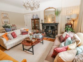 A living room with a fireplace and coffee table at The Old Vicarage in Carmarthen