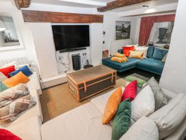 A living room with a television and sofa at The Old Vicarage in Carmarthen