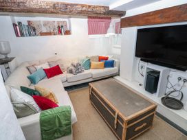 A snug with a sofa and television at The Old Vicarage in Carmarthen