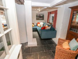 A living room with a sofa and armchair at The Old Vicarage in Carmarthen