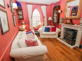 A living room with sofas and a fireplace at The Old Vicarage in Carmarthen