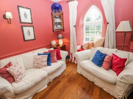 A sitting room with two sofas and a window at The Old Vicarage in Carmarthen