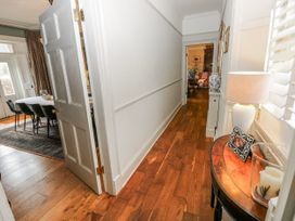 A hallway with a lamp and a table at The Old Vicarage in Carmarthen