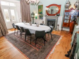 A dining room with a table and chairs at The Old Vicarage in Carmarthen