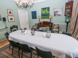 A dining room with a table and chairs at The Old Vicarage in Carmarthen