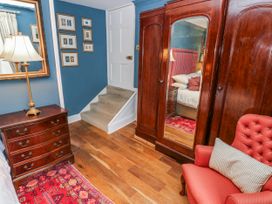 A bedroom with a wardrobe and a staircase at The Old Vicarage in Carmarthen