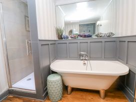 A bathroom with a bathtub and shower at The Old Vicarage in Carmarthen