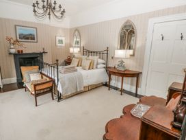 A bedroom with a bed and nightstand at The Old Vicarage in Carmarthen