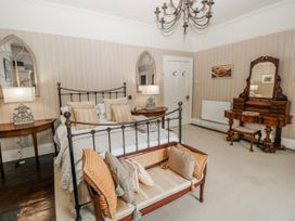 A bedroom with a bed and dressing table at The Old Vicarage in Carmarthen