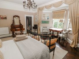 A bedroom featuring a bed and furniture at The Old Vicarage in Carmarthen