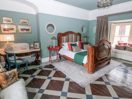 A bedroom with a bed and a sofa at The Old Vicarage in Carmarthen