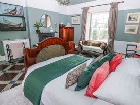 A bedroom with a bed and a sofa at The Old Vicarage in Carmarthen
