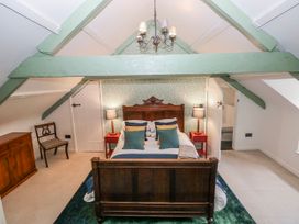 A bedroom with a bed and furniture at The Old Vicarage in Carmarthen