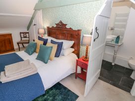 A bedroom with a bed and ensuite bathroom at The Old Vicarage in Carmarthen