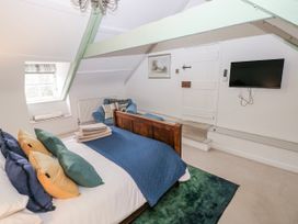 A bedroom with a bed and television at The Old Vicarage in Carmarthen