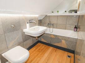 A bathroom with a sink, toilet, and bathtub at The Old Vicarage in Carmarthen