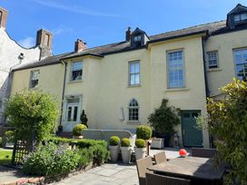 An outdoor area with seating and plants at The Old Vicarage in Laugharne