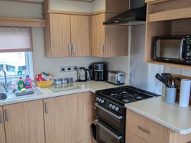 A kitchen with cabinets and appliances at 42 Laurel Rise in Primrose Valley