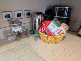 A kitchen counter with a kettle, coffee machine, and snacks at 42 Laurel Rise Primrose Valley