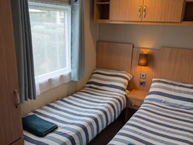 A bedroom with two beds and a window at 42 Laurel Rise Primrose Valley