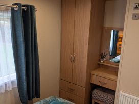 A bedroom with a wardrobe and desk at 42 Laurel Rise Primrose Valley