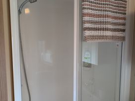 A shower area with towel and soap dispenser at 42 Laurel Rise Primrose Valley