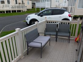 A sitting area with a couch and chairs at 42 Laurel Rise in Primrose Valley