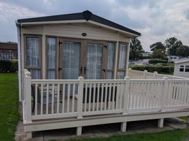 An outdoor cabin with a deck at 42 Laurel Rise, Primrose Valley