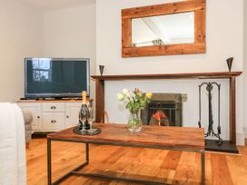 A living room with a television and a coffee table at The Old Post Office in York