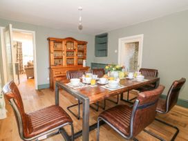 A dining room with a wooden table and chairs at The Old Post Office in York