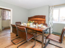 A dining room with a wooden table set for a meal at The Old Post Office in York