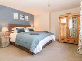 A bedroom with a bed and wardrobe at The Old Post Office in York