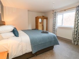 A bedroom with a bed and wardrobe at The Old Post Office in York