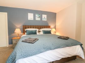 A bedroom with a large bed and nightstand at The Old Post Office York