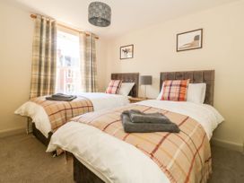 A bedroom with two beds and curtains at The Old Post Office in York
