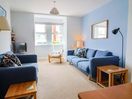 A living room with two sofas and a television at 4 Peaslands Road Sidmouth