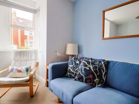 A living room with a sofa and armchair at 4 Peaslands Road Sidmouth