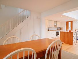 A kitchen with a dining area and staircase at 4 Peaslands Road in Sidmouth