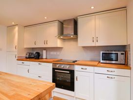 A kitchen with cabinets and appliances at 4 Peaslands Road in Sidmouth