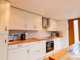 A kitchen with cabinets, oven, toaster and kettle at 4 Peaslands Road in Sidmouth