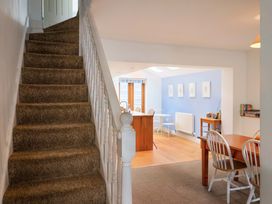 A hallway with a staircase leading to another room at 4 Peaslands Road Sidmouth