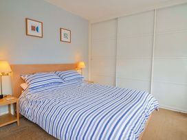 A bedroom with a bed and bedside tables at 4 Peaslands Road in Sidmouth