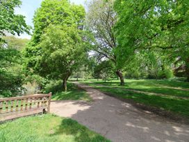 A park with a path and trees at 4 Peaslands Road in Sidmouth