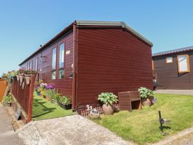 A house with a porch and planters at 33 Pendle View in Clitheroe