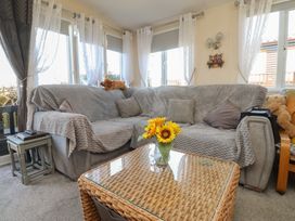 A living room with a sofa and coffee table at 33 Pendle View in Clitheroe