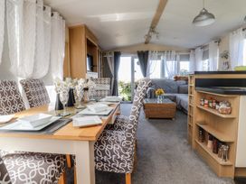 A dining area with a table and chairs at 33 Pendle View Clitheroe