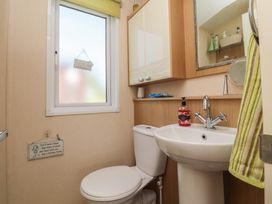 A bathroom with a toilet and wash basin at 33 Pendle View, Clitheroe